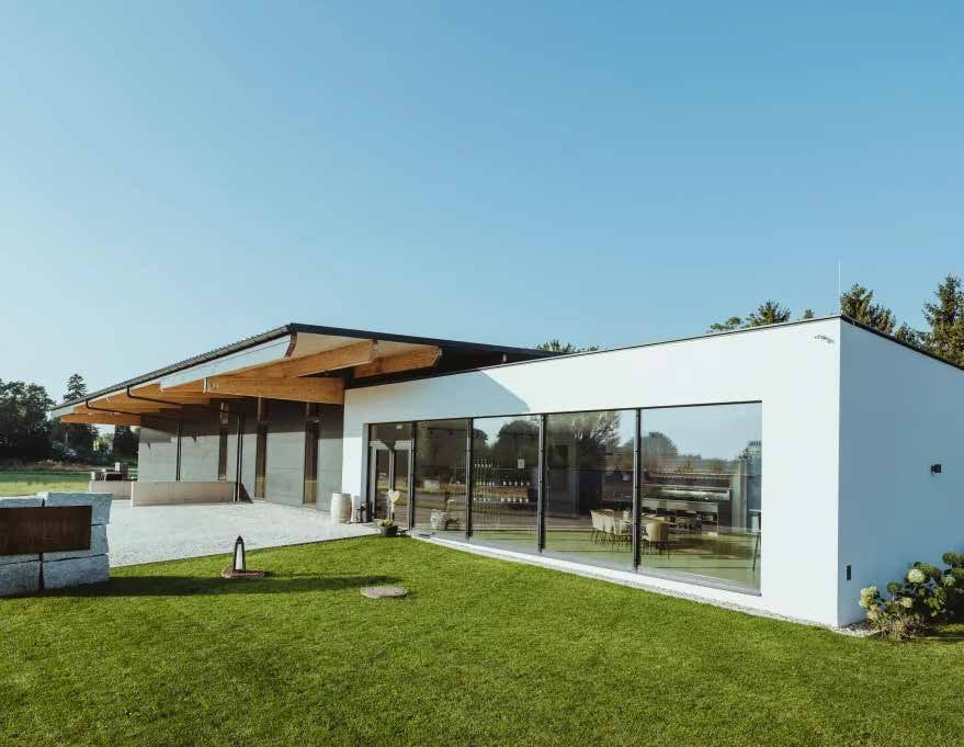 Das neue Gutsgebäude von Gmeinböck in Poysdorf, ein heller Flachbau mit Holzdach und großer Glasfront