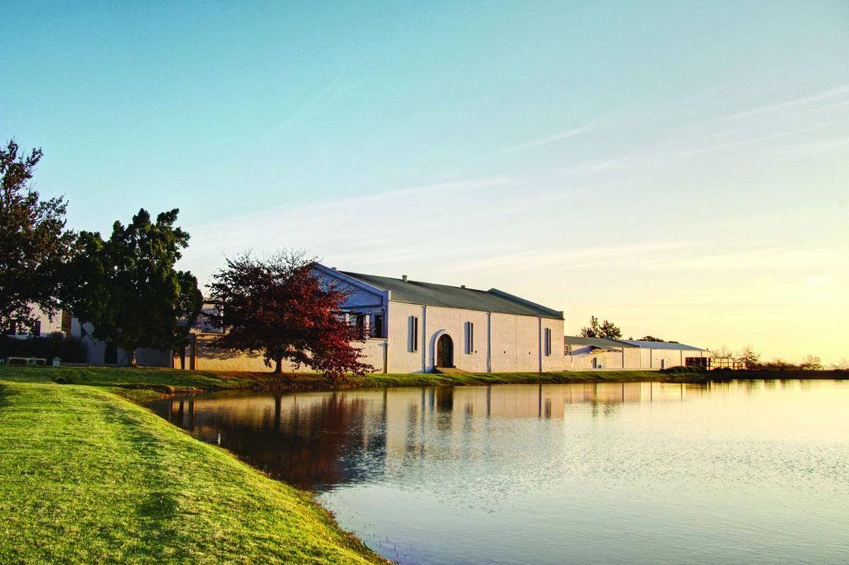 Das Weingut L’Avenir mit Gebäude und Wasserfläche in Stellenbosch